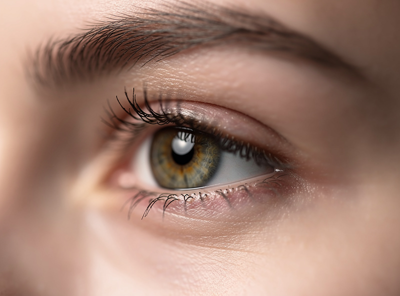 Close-up of a persons eye in sharp focus demonstrating shallow depth of field control at f/1.4 on a portrait lens