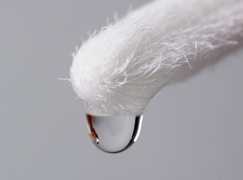 Sensor swab with cleaning fluid applied, close-up macro shot