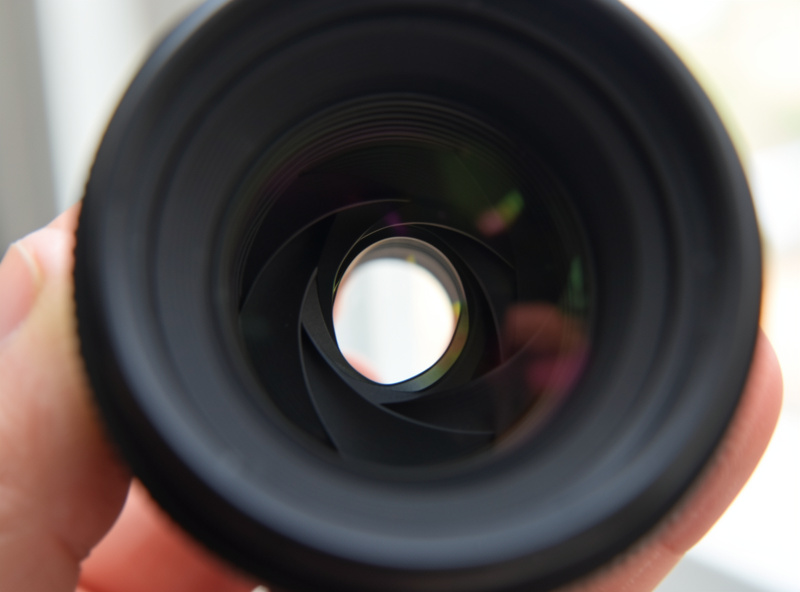 Aperture blades visible inside a fast prime lens held up to soft window light