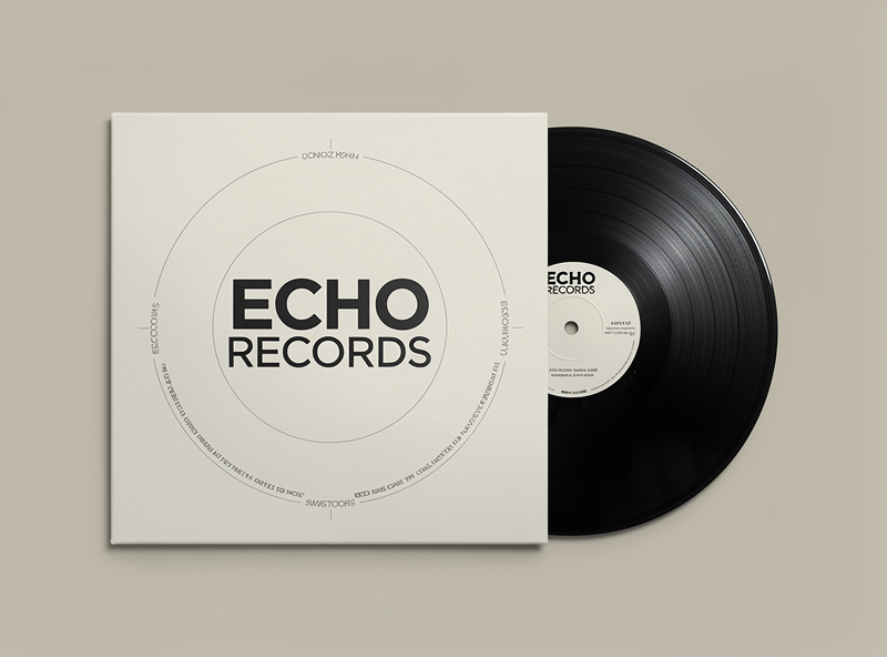Overhead macro shot of vinyl record label with typography and color details, diffused soft light, clean product photography on dark background