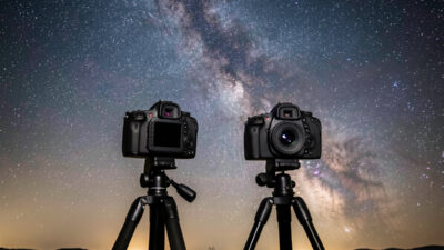Mirrorless camera and a DSLR side by side set up for Milky Way photography under the stars