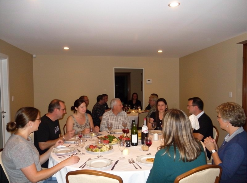 Indoor gathering photographed with soft bounced flash off a white ceiling, natural-looking light
