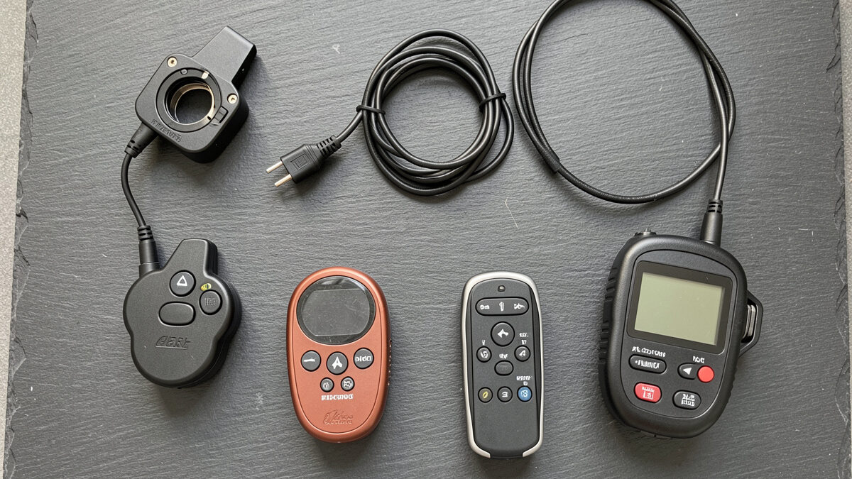 Flat lay of camera remote shutter releases and intervalometers on a slate surface
