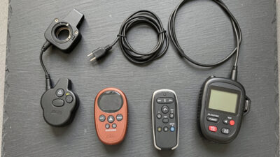 Flat lay of camera remote shutter releases and intervalometers on a slate surface