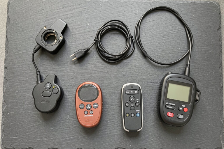 Flat lay of camera remote shutter releases and intervalometers on a slate surface