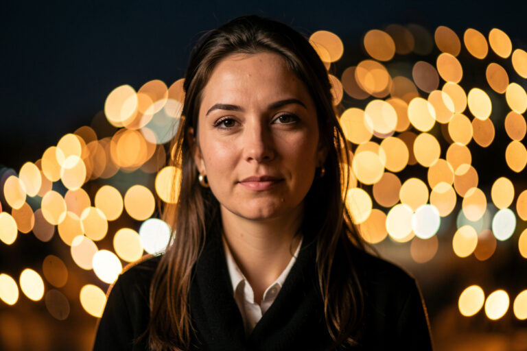 Glowing field of round bokeh balls from city lights behind a portrait subject