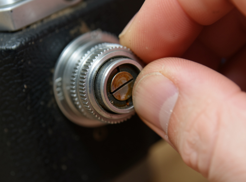 Checking the aperture blades of a vintage lens for oil while working the aperture ring