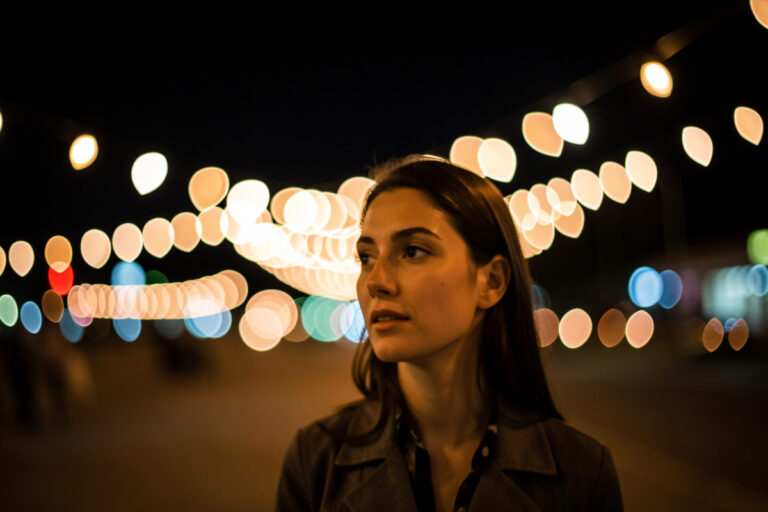 Cat-eye shaped background bokeh highlights swirling around a subject shot wide open