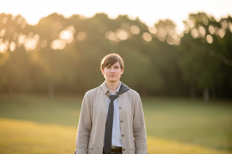 Portrait with strong subject separation rendering a deeply blurred background without a fast lens