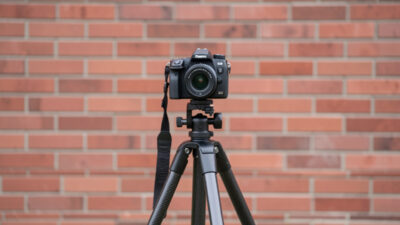 Camera on a carbon tripod aimed squarely at a flat brick wall for a decentering test