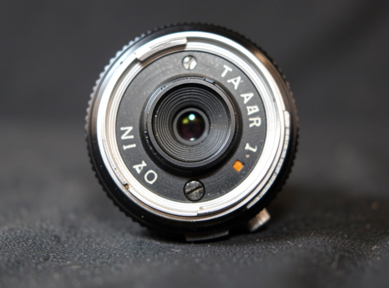 Close-up of an M42 Super-Takumar lens rear showing the aperture pin and A/M switch